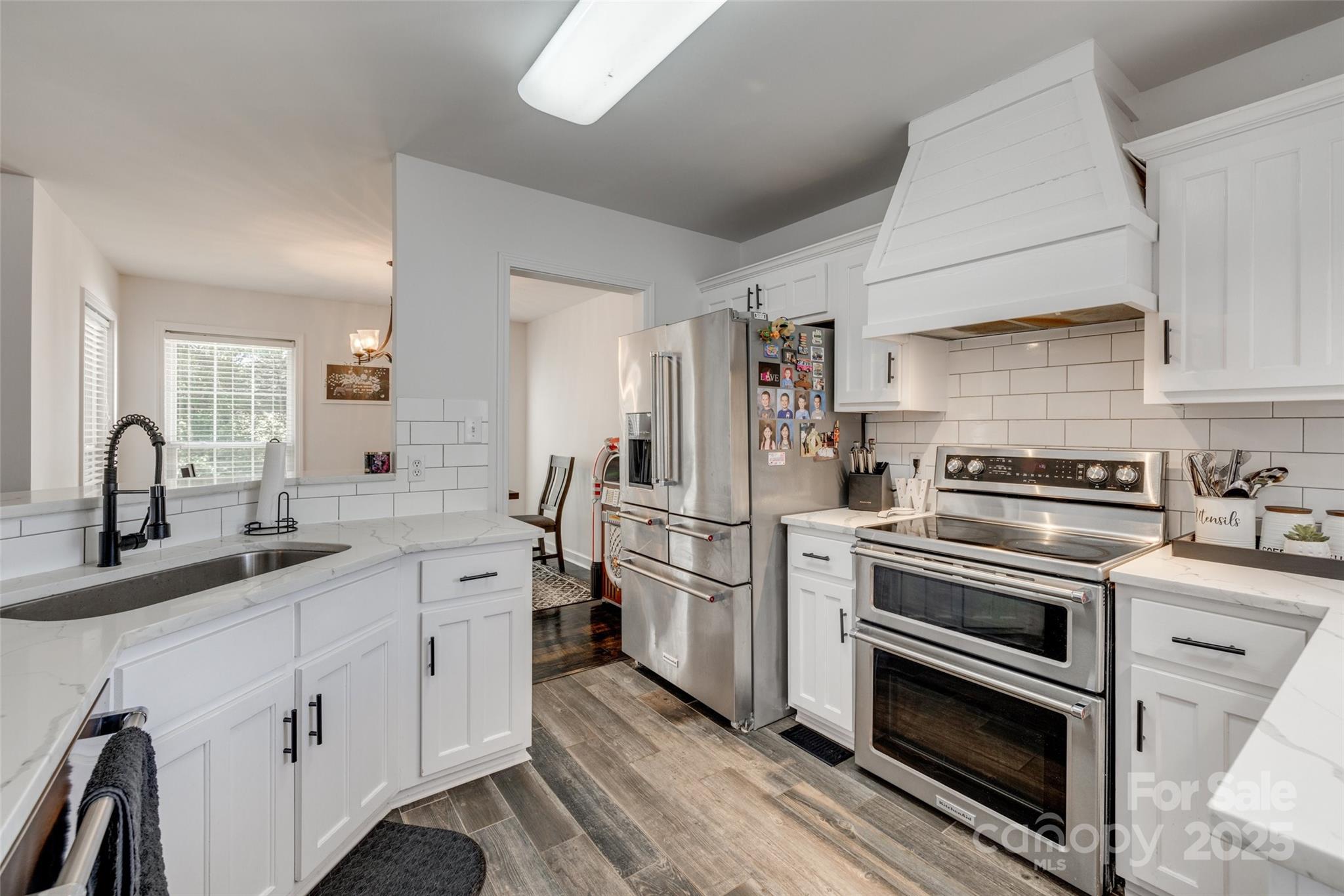 1140 Landsdown Drive Salisbury, NC 28147 - Photo 8 of 37 a kitchen with white cabinets and stainless steel appliances
