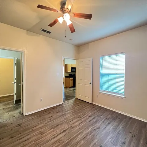 a bathroom with a granite countertop toilet sink and mirror