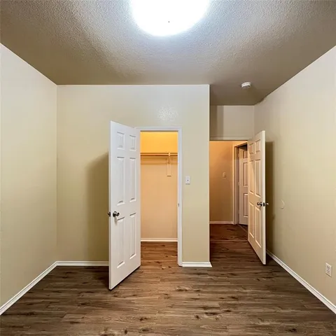 an empty room with wooden floor and a window