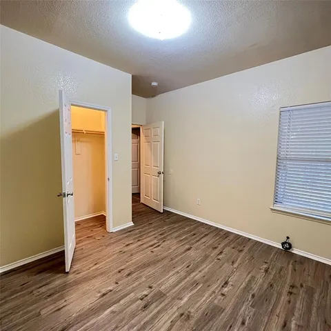 a view of a yard with large trees