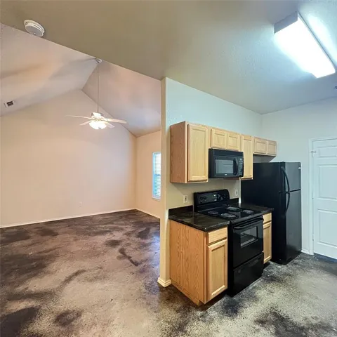 a kitchen with stainless steel appliances a refrigerator and a stove top oven