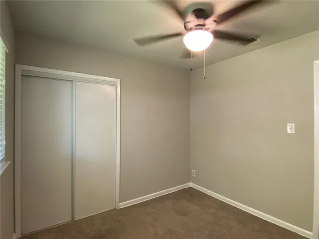 en empty room with a fan