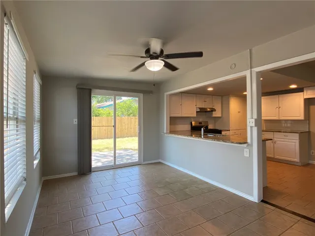 a view of a kitchen with a sink and a large window