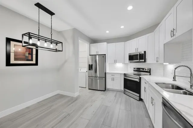 a kitchen with stainless steel appliances a refrigerator stove and microwave