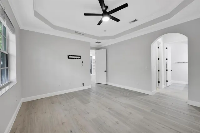 a view of empty room with wooden floor