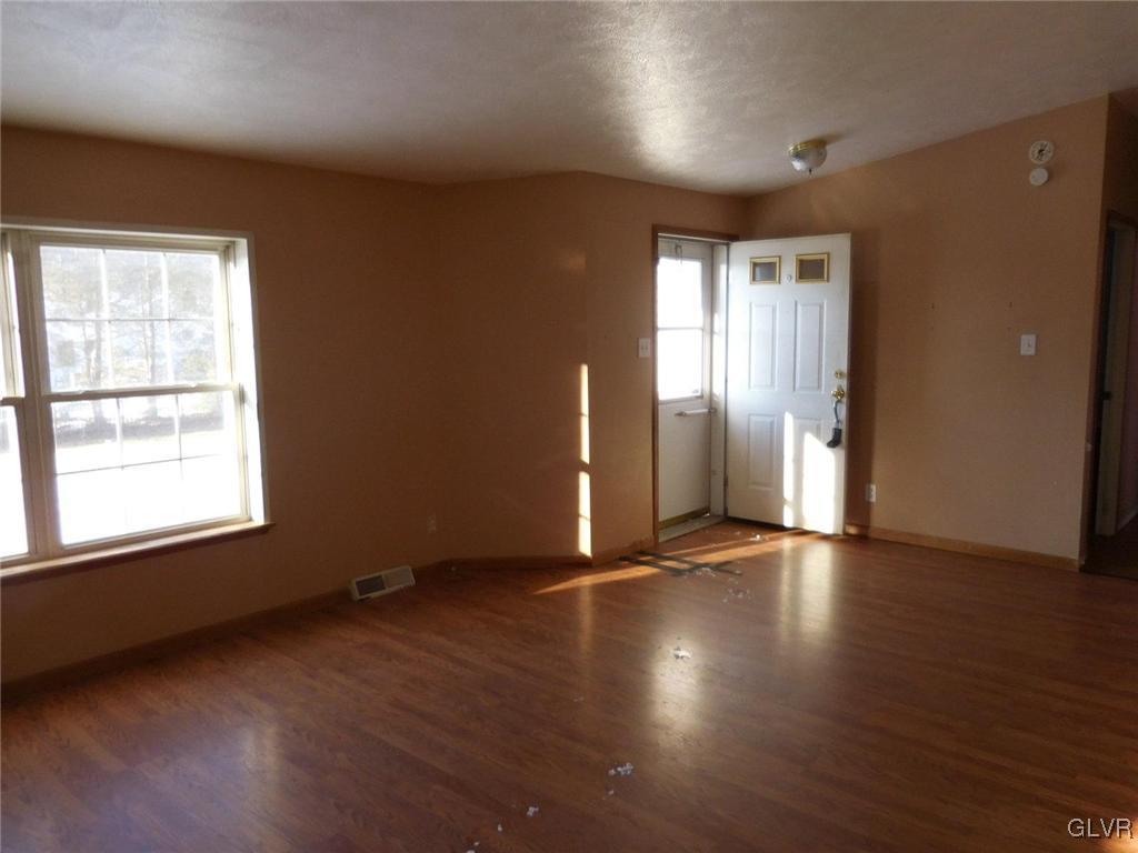 698 Point Phillips Road Bath, PA 18014 - Photo 2 of 10 an empty room with wooden floor and windows
