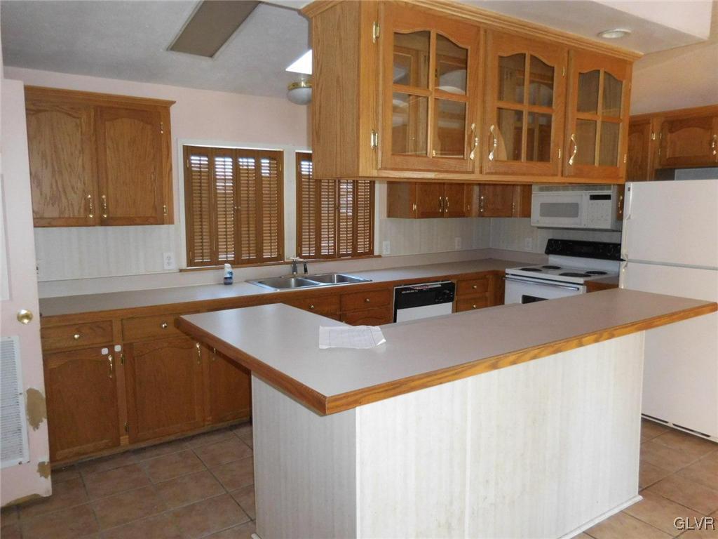698 Point Phillips Road Bath, PA 18014 - Photo 3 of 10 a kitchen with stainless steel appliances granite countertop a sink and a stove