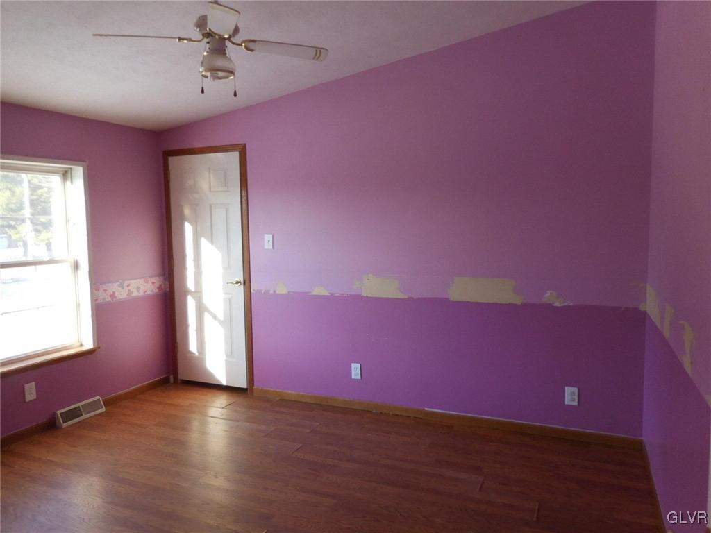 698 Point Phillips Road Bath, PA 18014 - Photo 6 of 10 a view of empty room with wooden floor and fan