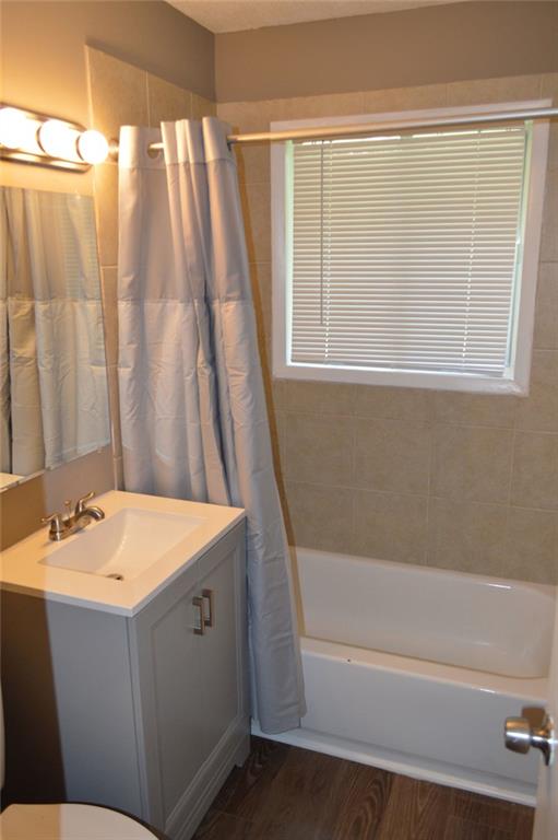 8859 Main Street, Unit 2 Woodstock, GA 30188 - Photo 11 of 12 a bathroom with a sink and a bathtub