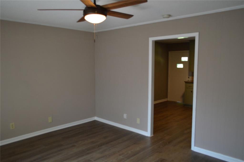 8859 Main Street, Unit 2 Woodstock, GA 30188 - Photo 2 of 12 wooden floor in an empty room with a window