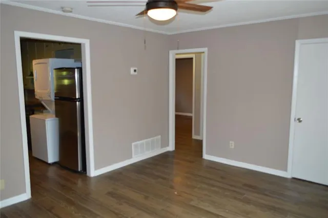 an empty room with wooden floor and closet