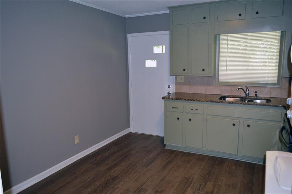 8859 Main Street, Unit 2 Woodstock, GA 30188 - Photo 4 of 12 a room with a sink cabinets and wooden floor