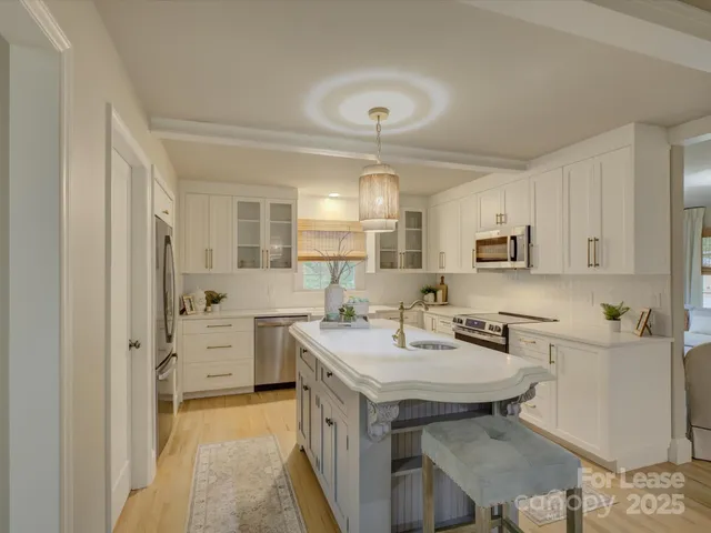 a kitchen with appliances cabinets and furniture