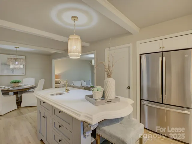 a kitchen with a sink stainless steel appliances and cabinets
