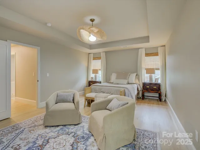 a bedroom with furniture and a large window