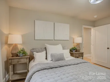 a bedroom with a bed and a lamp