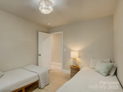a bedroom with a bed and a lamp