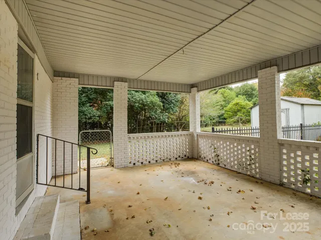 a view of a porch with wooden floor and roof