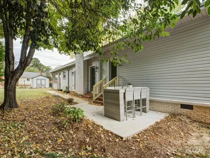 a white house that has a tree in front of it