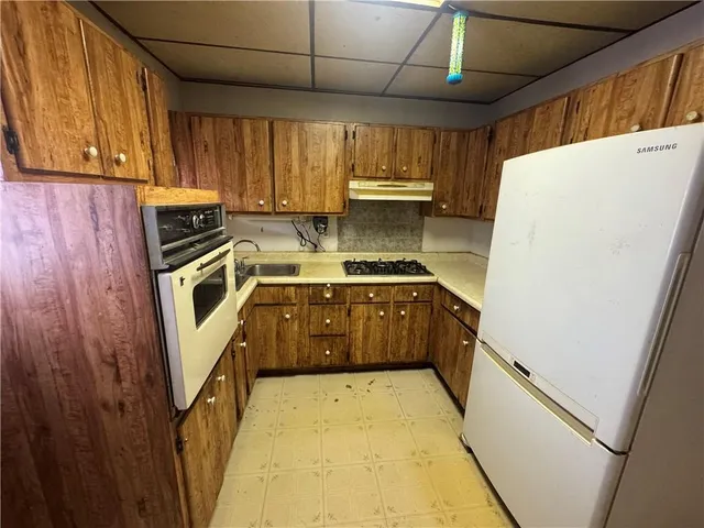 a kitchen with a stove a sink and a refrigerator