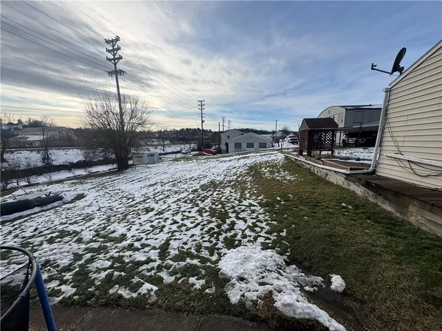 a view of a house with wooden fence