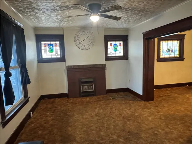 a view of an empty room with a fireplace