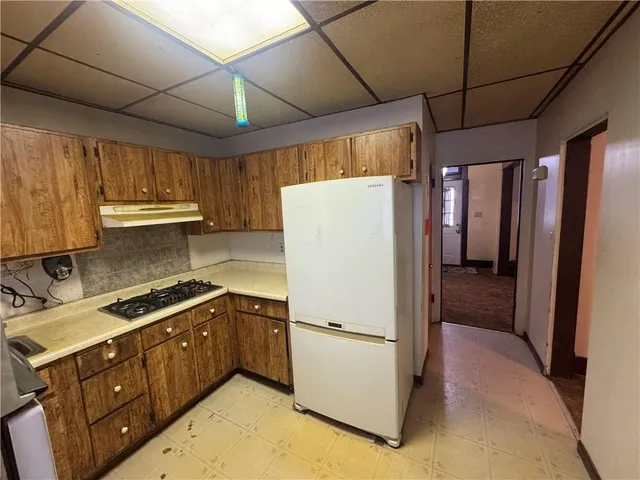 a kitchen with a refrigerator a sink and cabinets