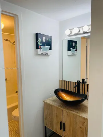 a bathroom with a bath tub with a shower