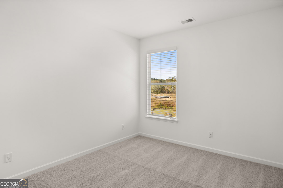 408 Hazel Drive Locust Grove, GA 30248 - Photo 12 of 32 an empty room with windows
