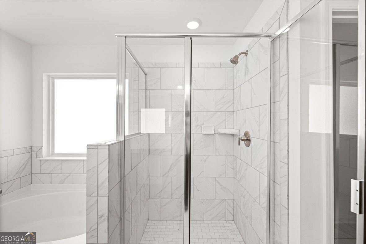 408 Hazel Drive Locust Grove, GA 30248 - Photo 20 of 32 a bathroom with a shower and a tub