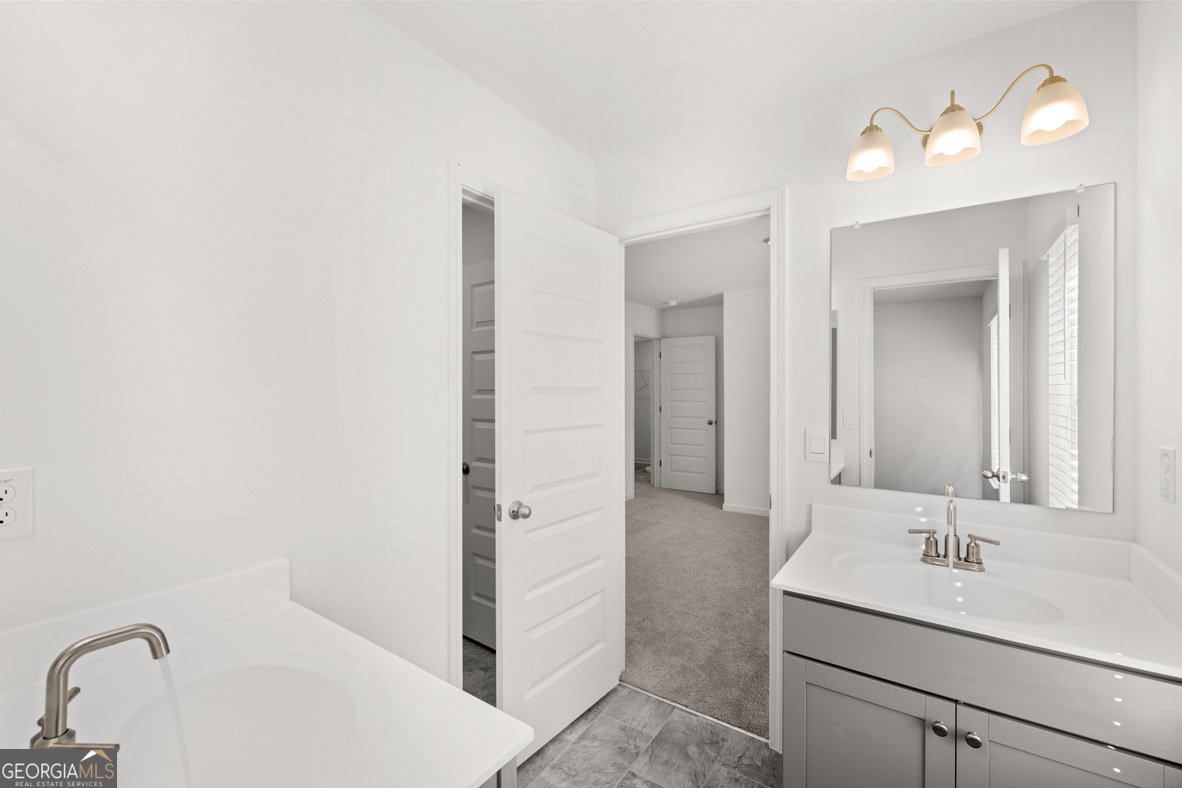 408 Hazel Drive Locust Grove, GA 30248 - Photo 25 of 32 a bathroom with a sink and a mirror