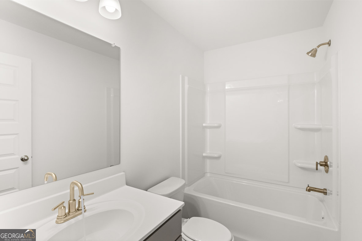408 Hazel Drive Locust Grove, GA 30248 - Photo 28 of 32 a bathroom with a bathtub shower sink vanity and toilet