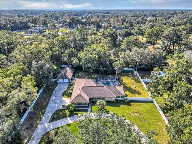 an aerial view of house with yard swimming pool and outdoor seating