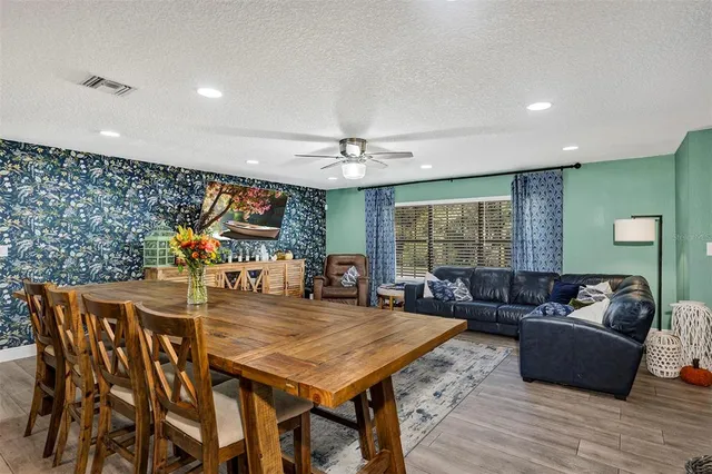 a kitchen with stainless steel appliances kitchen island granite countertop a sink a stove and cabinets
