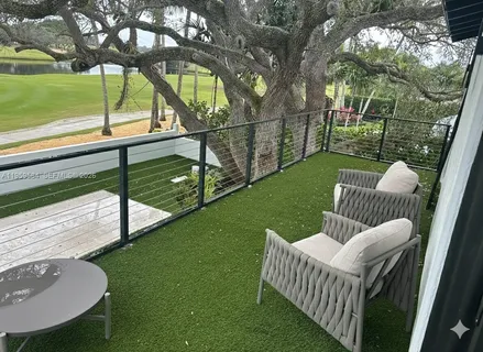a view of a deck with couches table and chairs