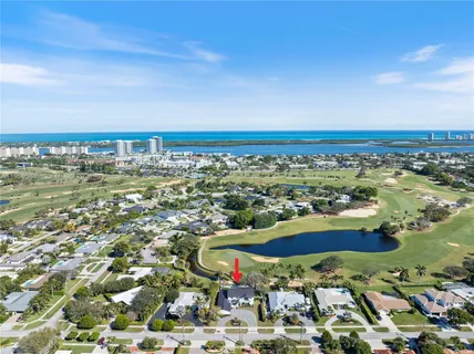 an aerial view of a houses with a swimming pool