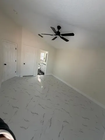 a view of empty room with ceiling fan