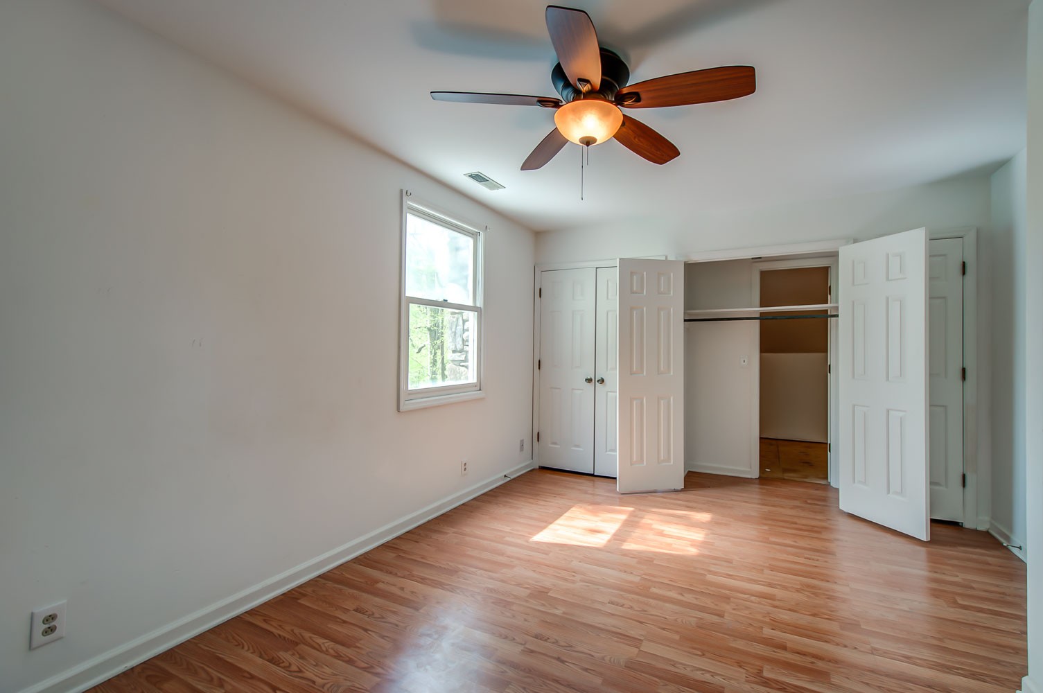 1136 Dora Whitley Road Franklin, TN 37064 - Photo 23 of 37 an empty room with wooden floor chandelier fan and windows