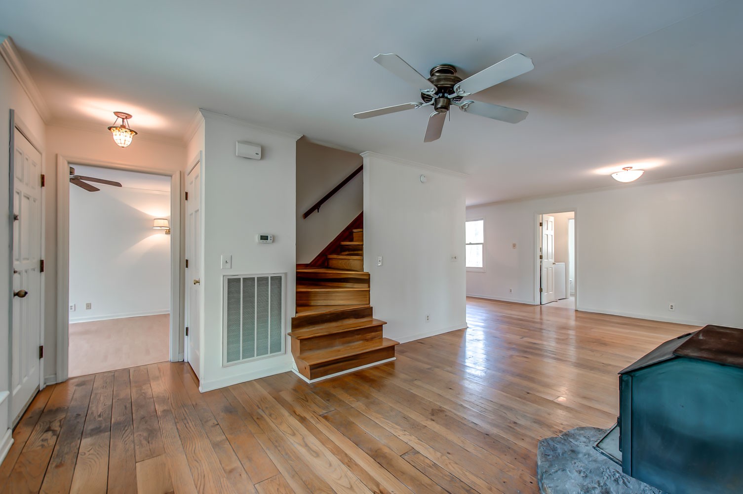 1136 Dora Whitley Road Franklin, TN 37064 - Photo 6 of 37 a view of an empty room with wooden floor and a ceiling fan