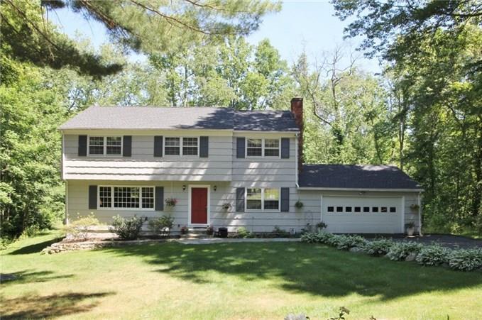 35 Cousins Road Stamford, CT 06903 - Photo 1 of 1 front view of a house with a garden