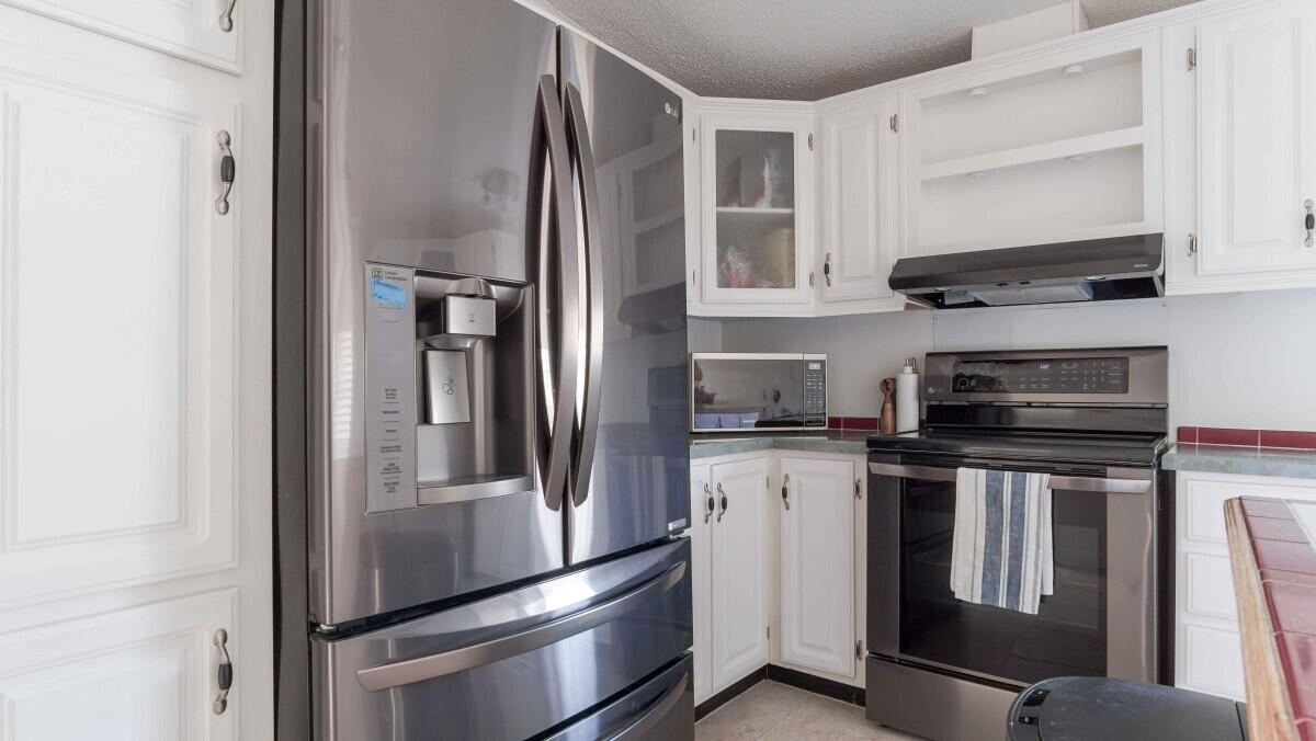 119 Edgewood Terrace Santa Rosa Beach, FL 32459 - Photo 2 of 23 a kitchen with stainless steel appliances granite countertop a refrigerator a stove and a sink