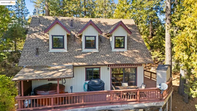 a view of house with roof deck and furniture