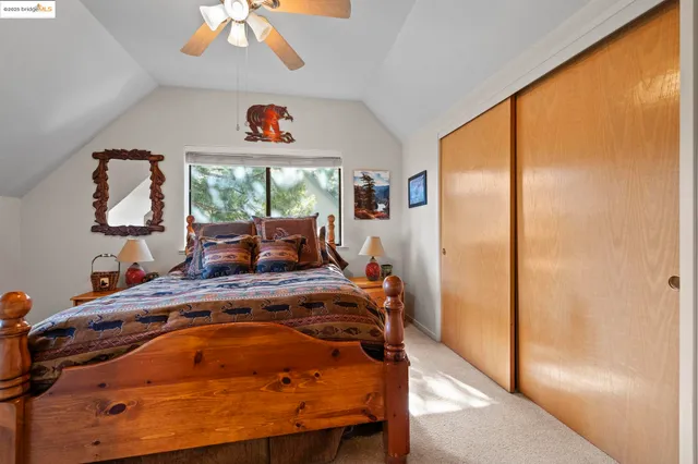 a bed sitting in a bedroom next to a window