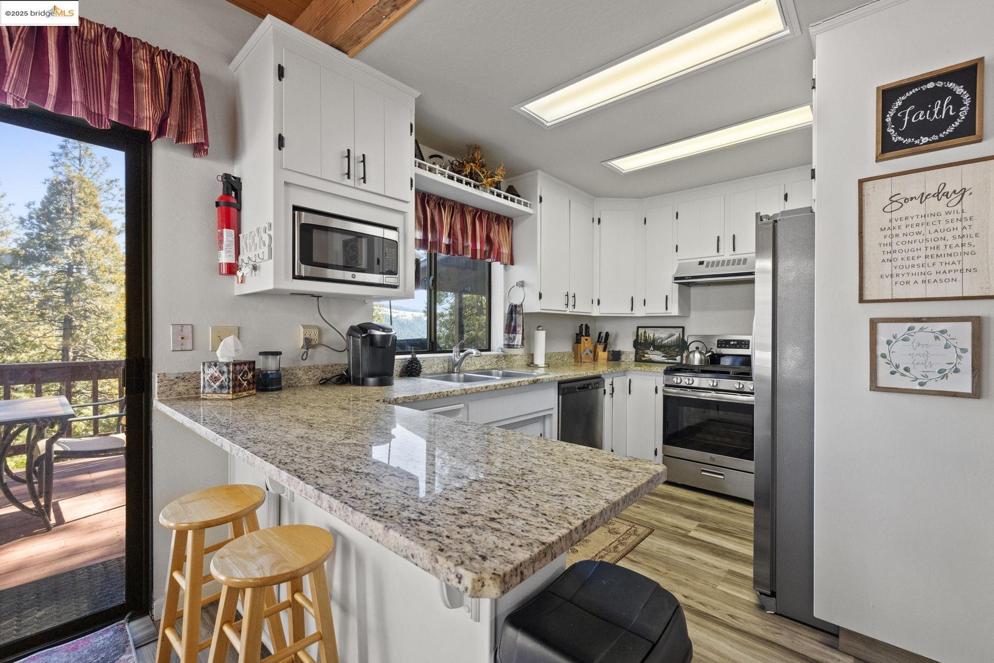 29803 West Mono Road Cold Springs, CA 95335 - Photo 9 of 51 a kitchen with stainless steel appliances granite countertop a stove refrigerator and a sink