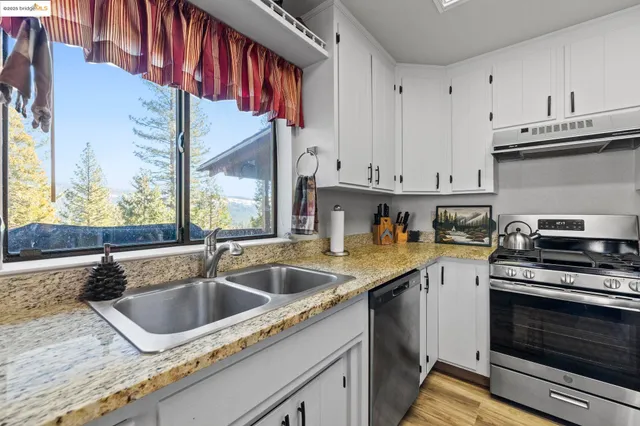 a kitchen that has a sink and a stove