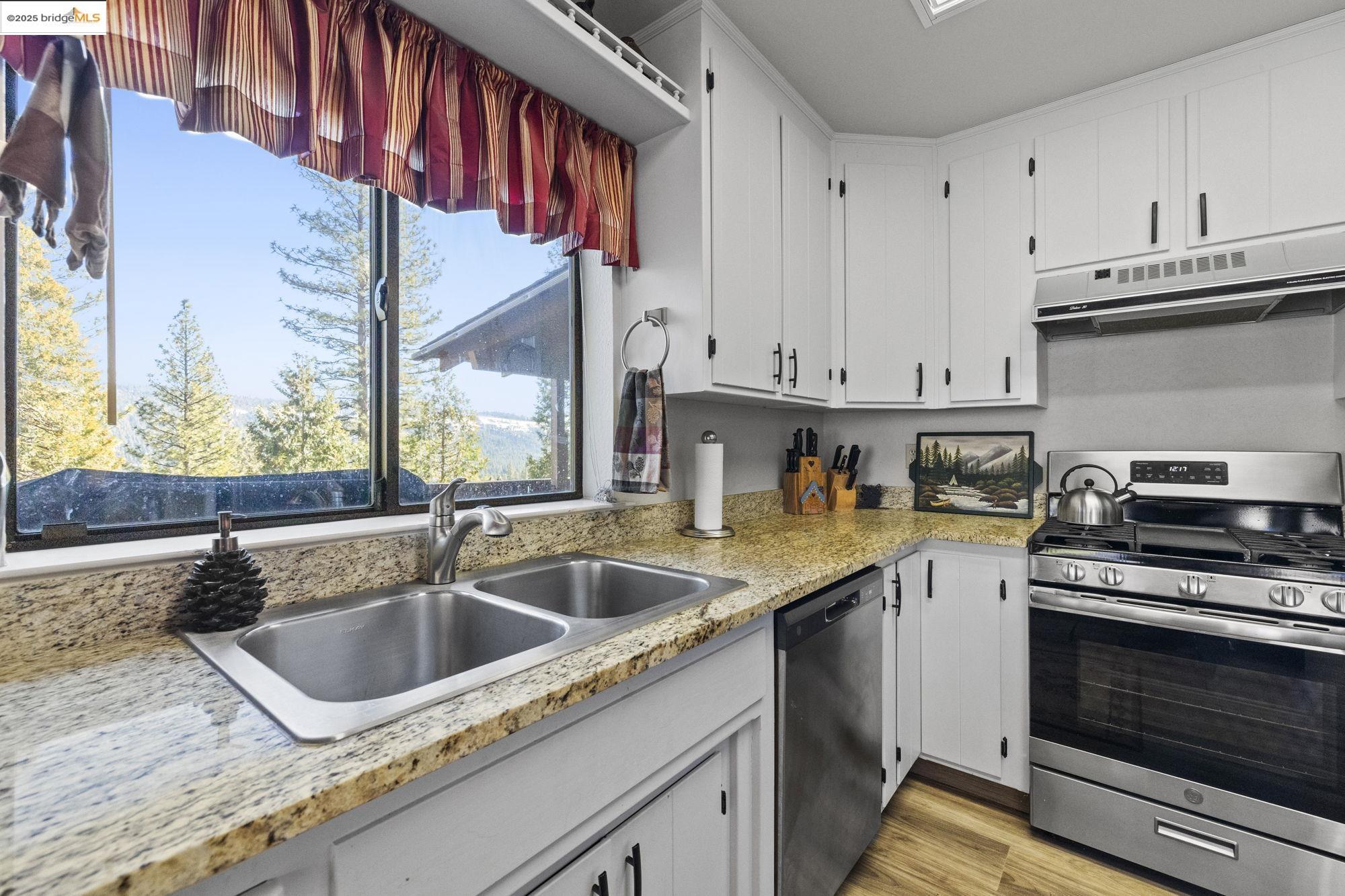29803 West Mono Road Cold Springs, CA 95335 - Photo 10 of 51 a kitchen that has a sink and a stove