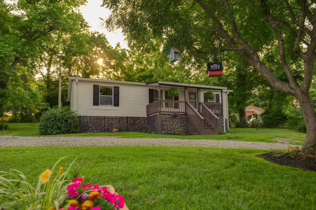 a front view of house with yard and green space