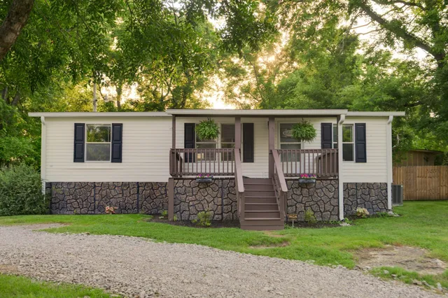a view of backyard with seating area and green space