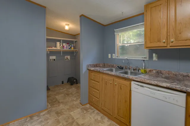 a kitchen with a sink refrigerator and a refrigerator