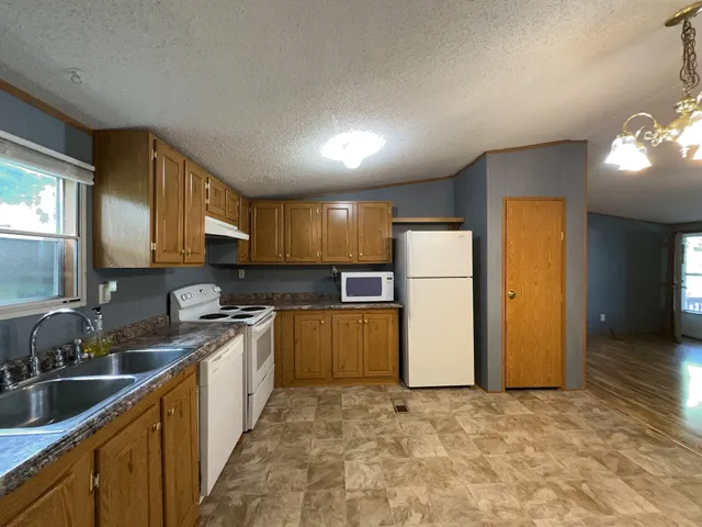 a kitchen with a sink and a refrigerator